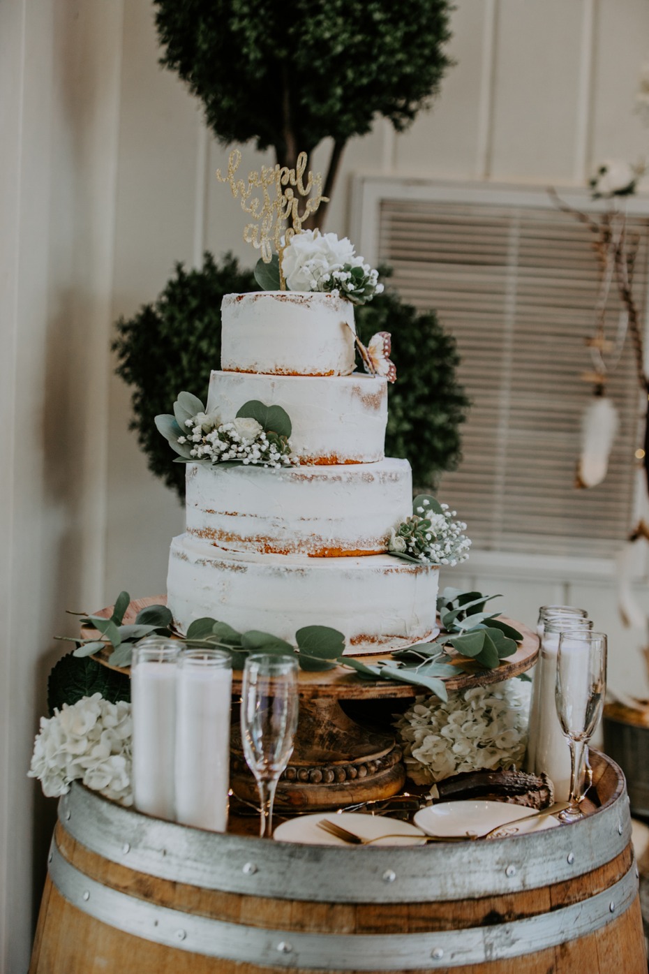 Elegant rustic wedding cake with floral decor on barrel