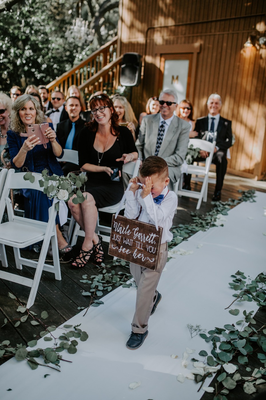 Flower boy cries at wedding while carrying the sign wait till you see her