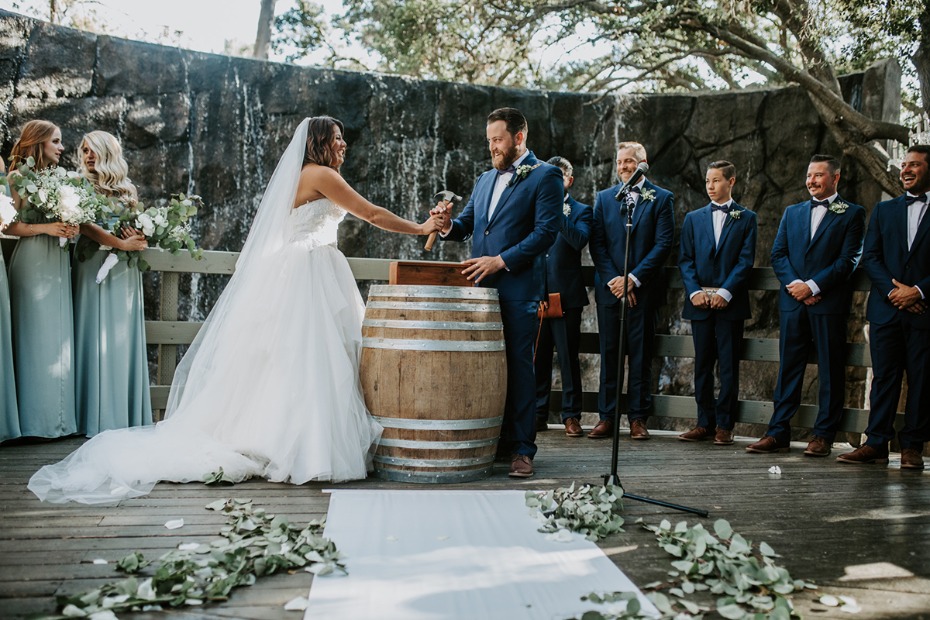 Bride and groom hammering a barrel during their wedding ceremony
