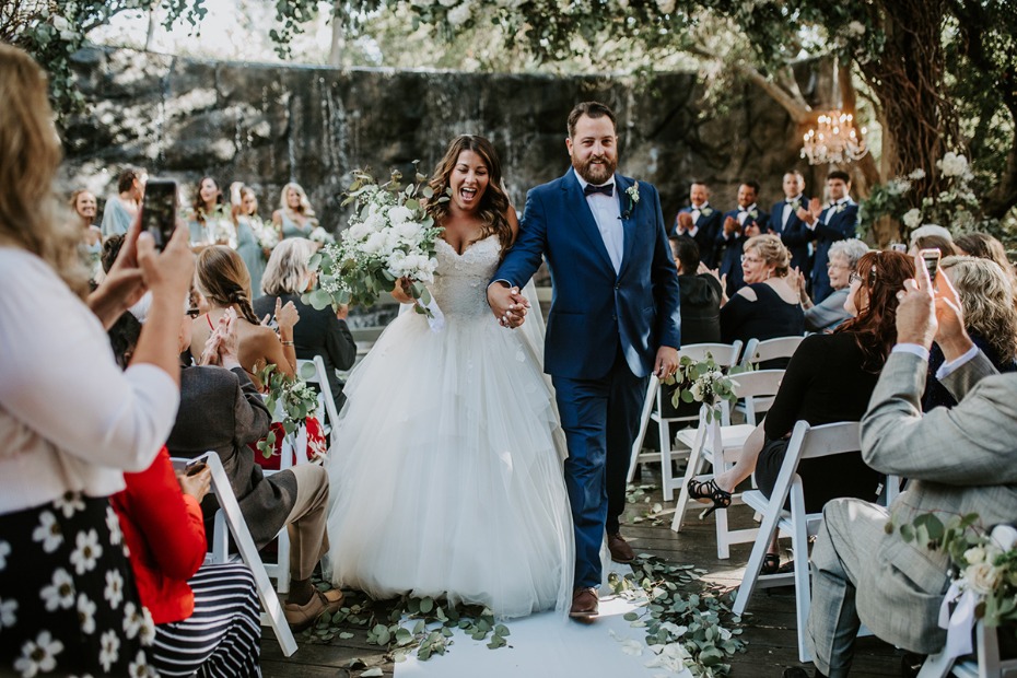 Newly married couple joyfully walks the aisle, wedding celebration