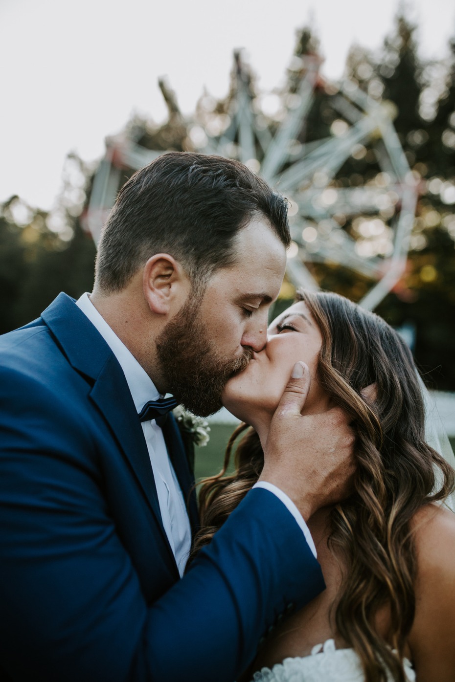 Newlyweds sharing a passionate kiss at their wedding ceremony