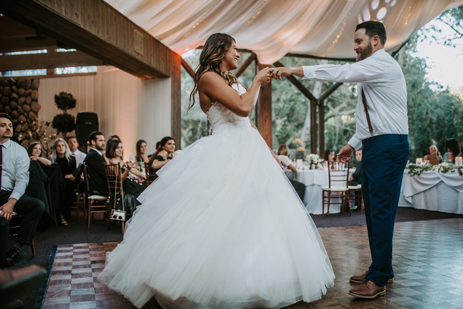 Bride and groom share a joyful first dance at their wedding reception