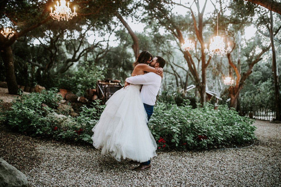 Couple in love share a kiss during an outdoor wedding ceremony