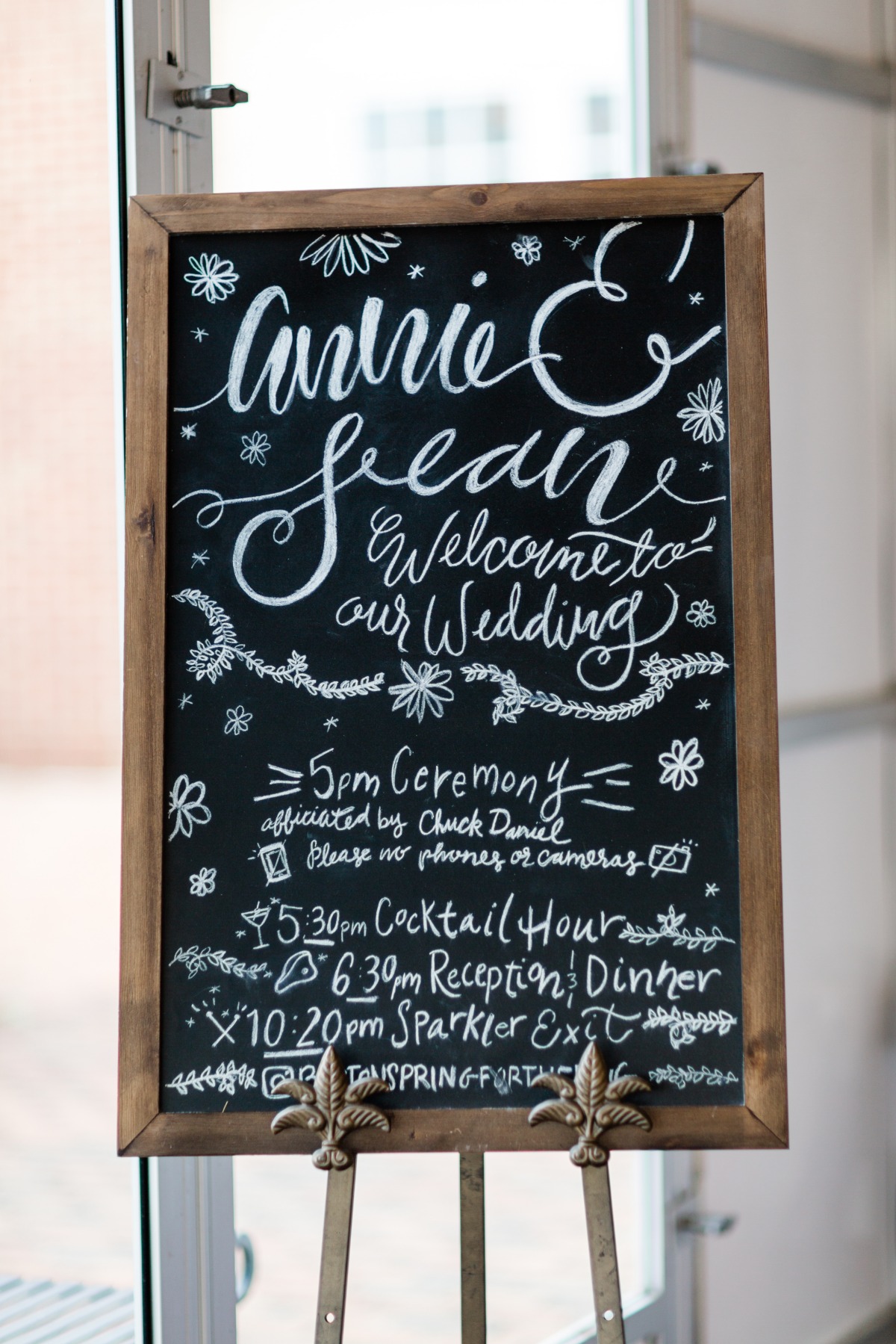 Chalkboard wedding sign with names, schedule, and welcome message