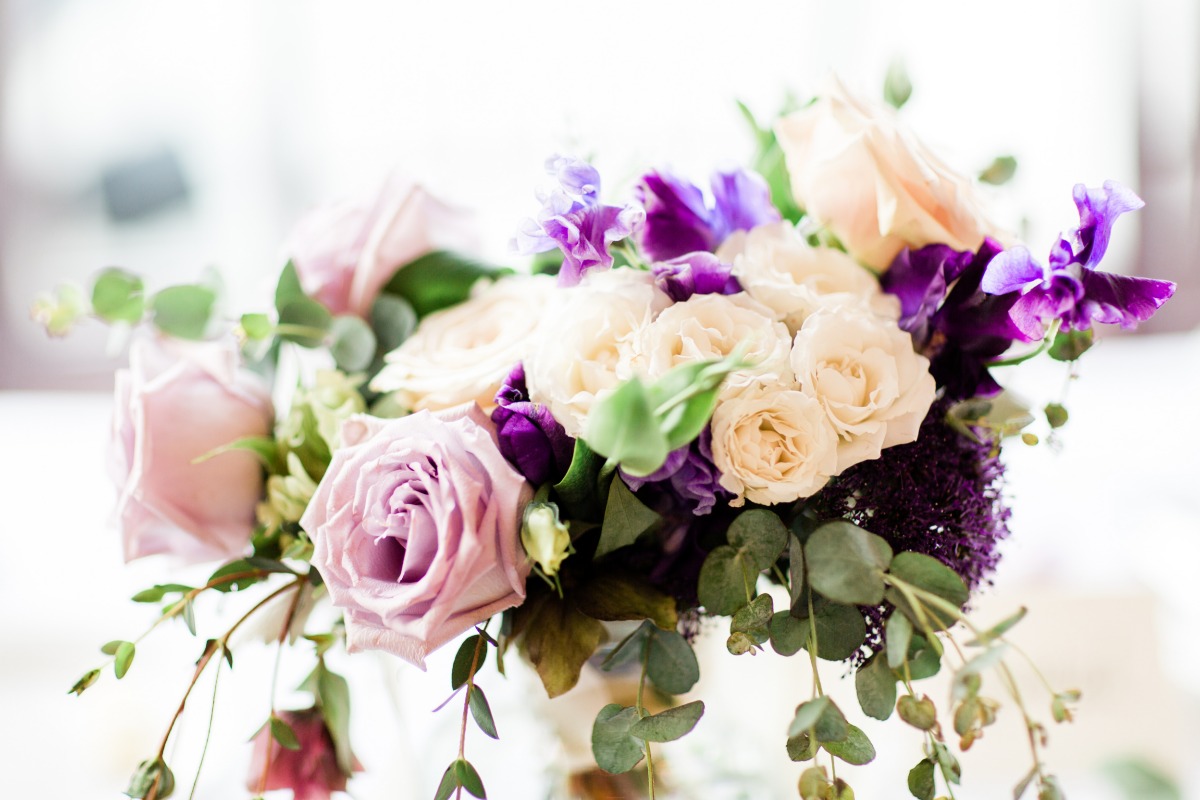 Elegant bouquet of roses and purple flowers arrangement close-up