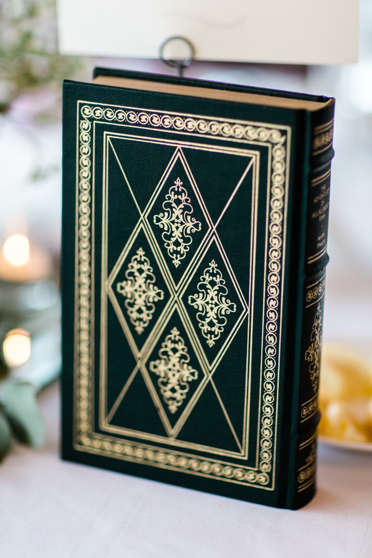 Green hardcover book with gold accents and ornate design on the cover
