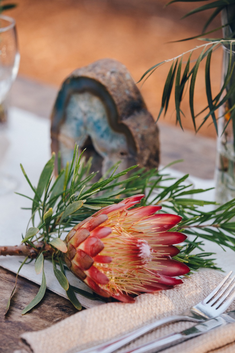Protea flower table setting with geode and greenery close-up