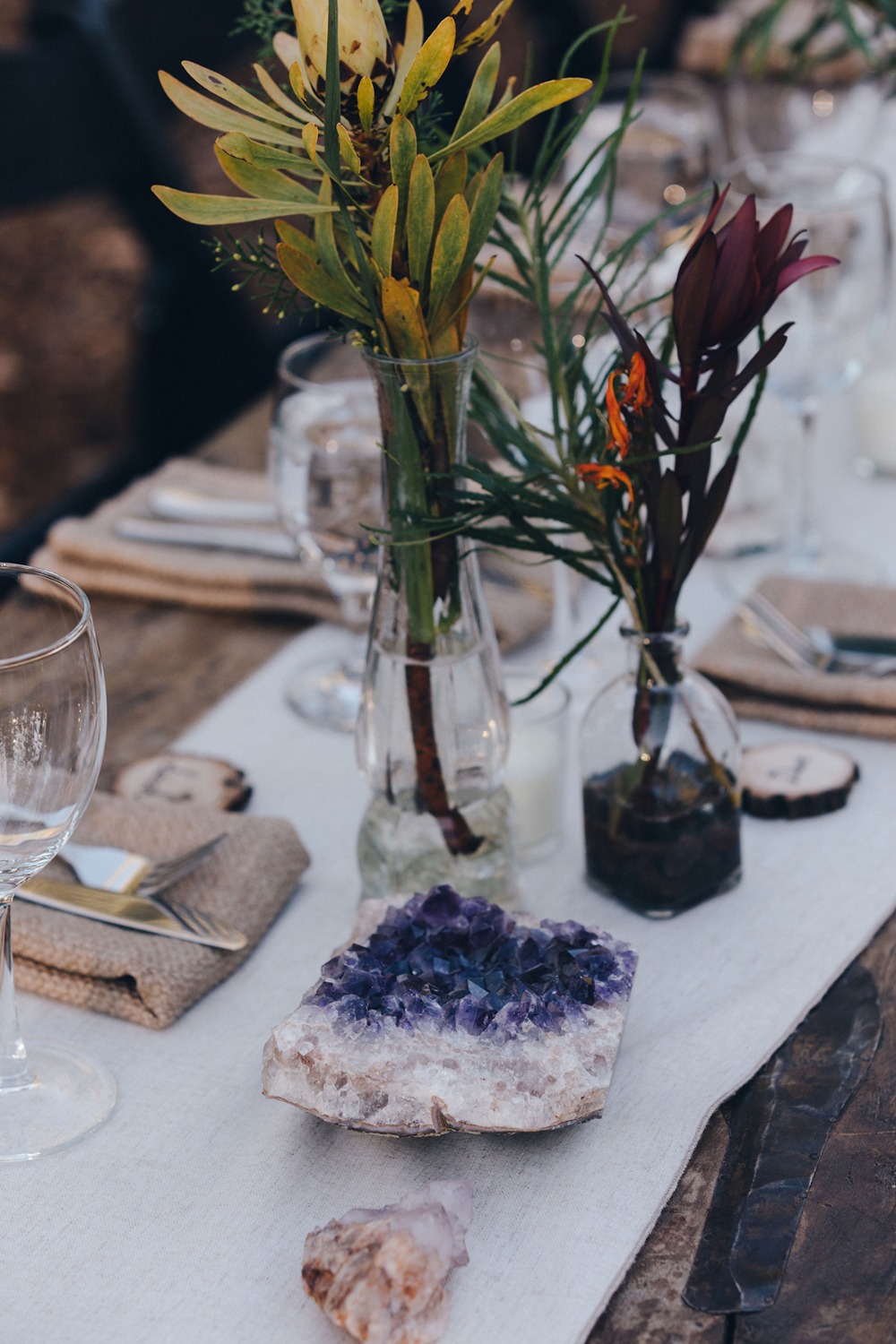 Beautiful table setting with amethyst and floral arrangements