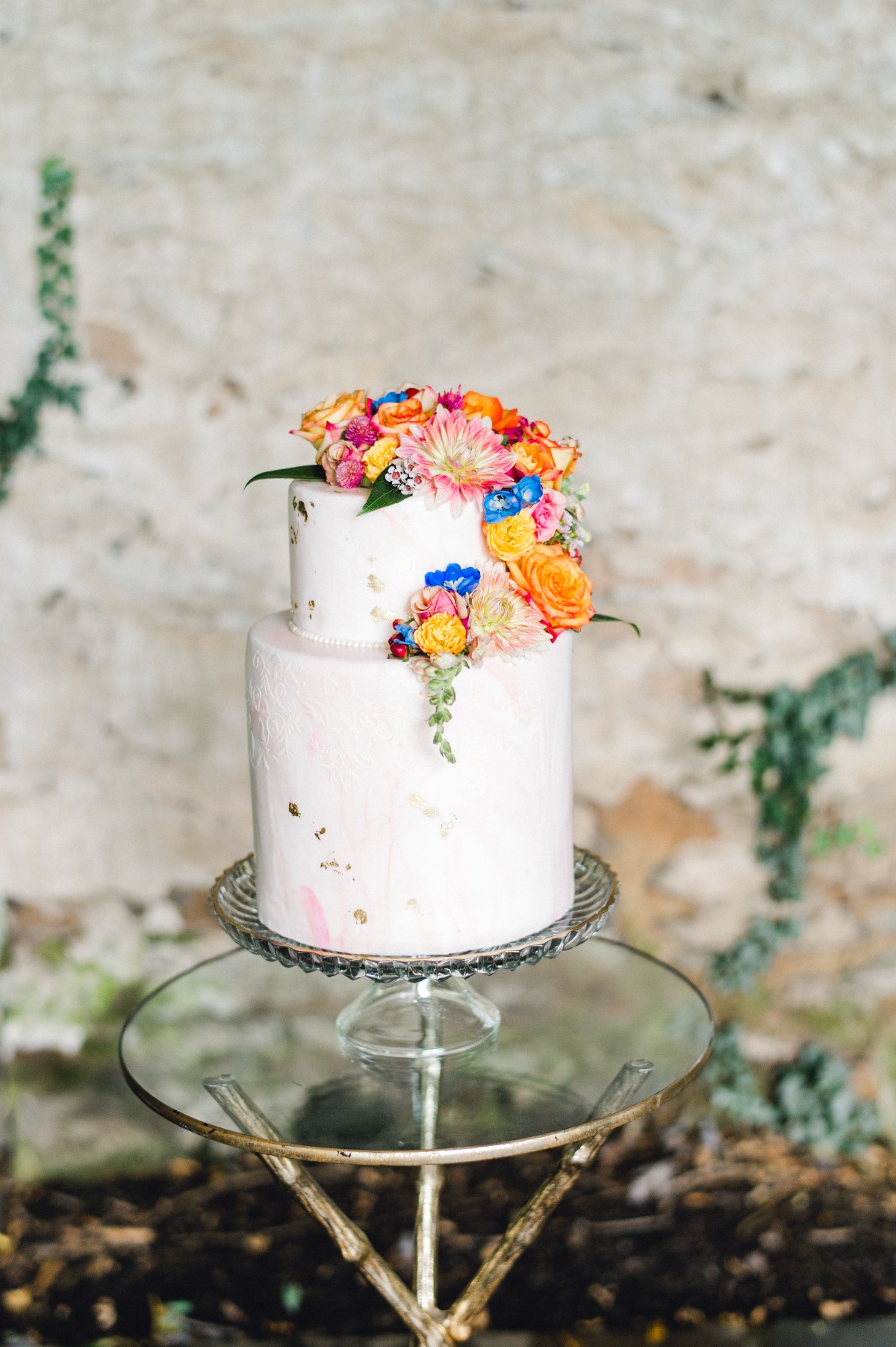 Dusty mauve wedding cake with bright florals