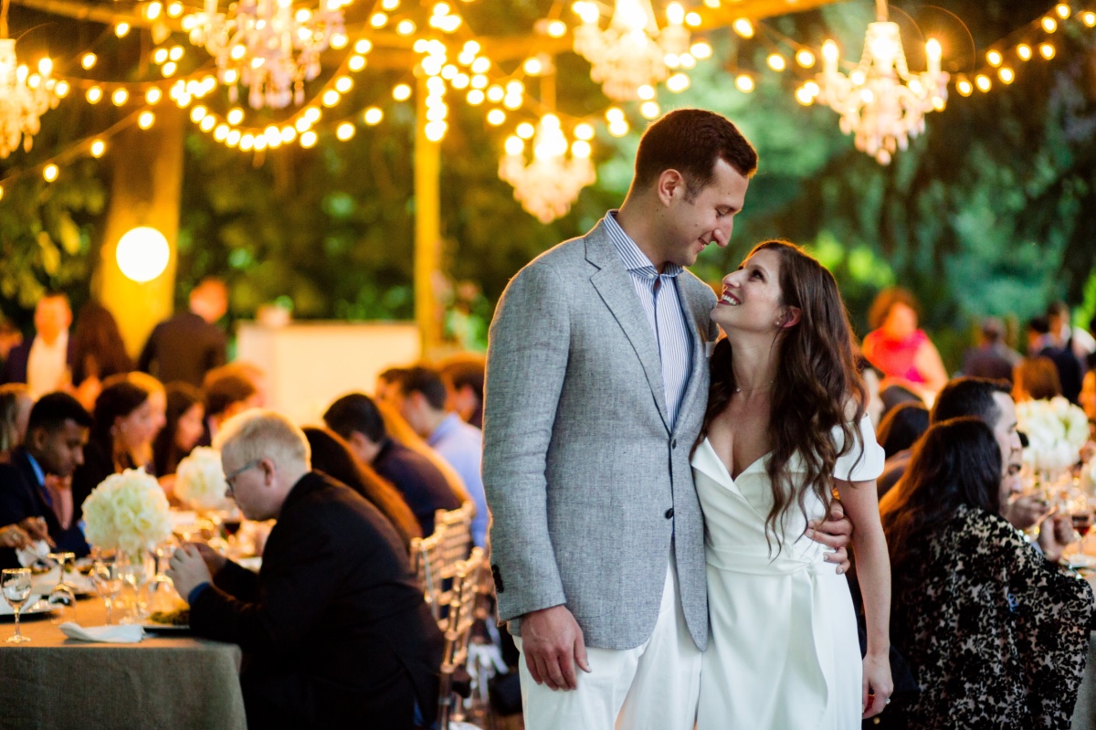 Happy couple embracing at outdoor wedding reception