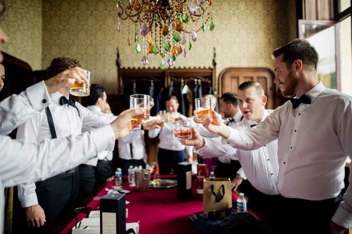 Groomsmen toasting with whiskey before the wedding