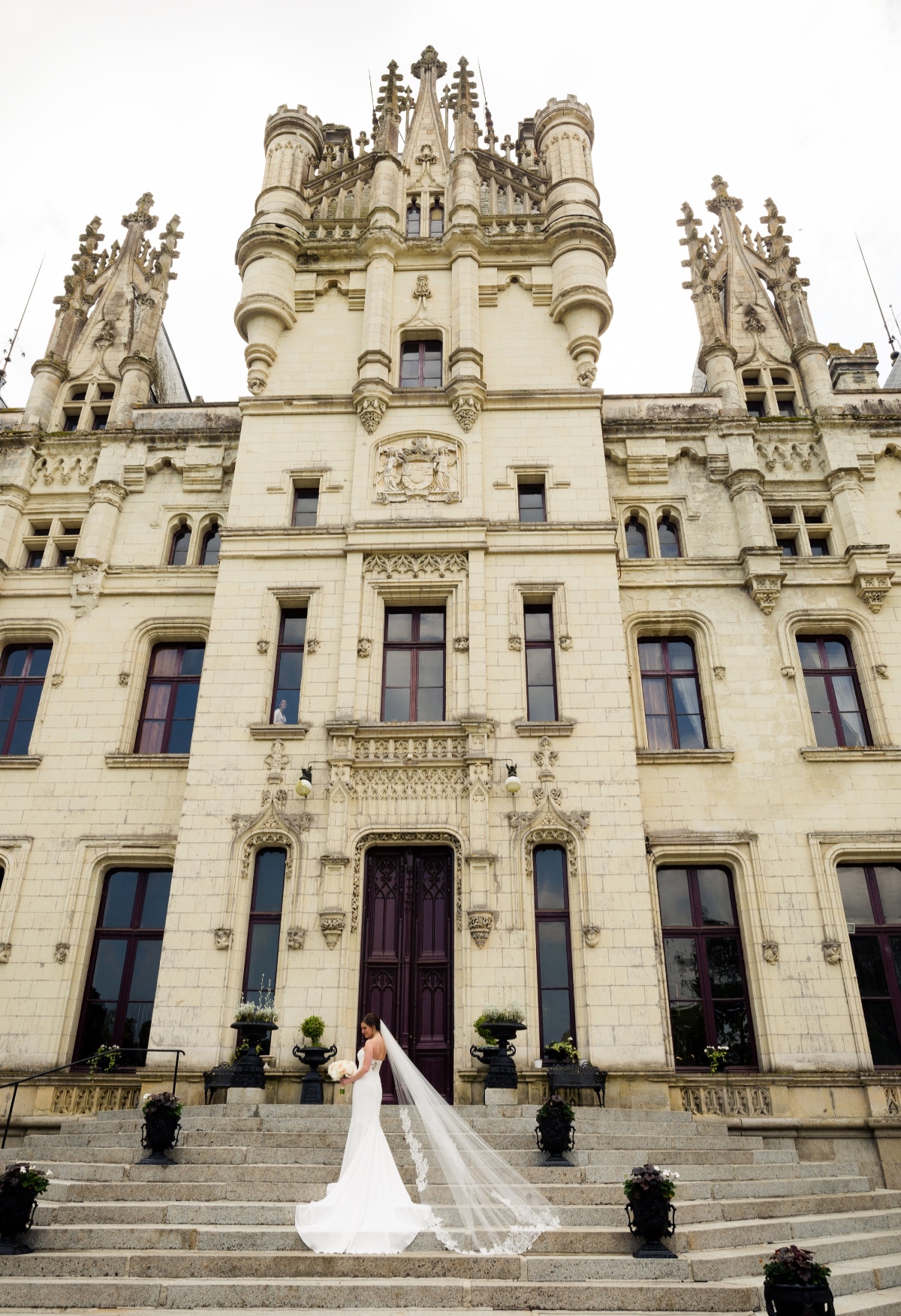 Bride in white dress at grand castle wedding venue