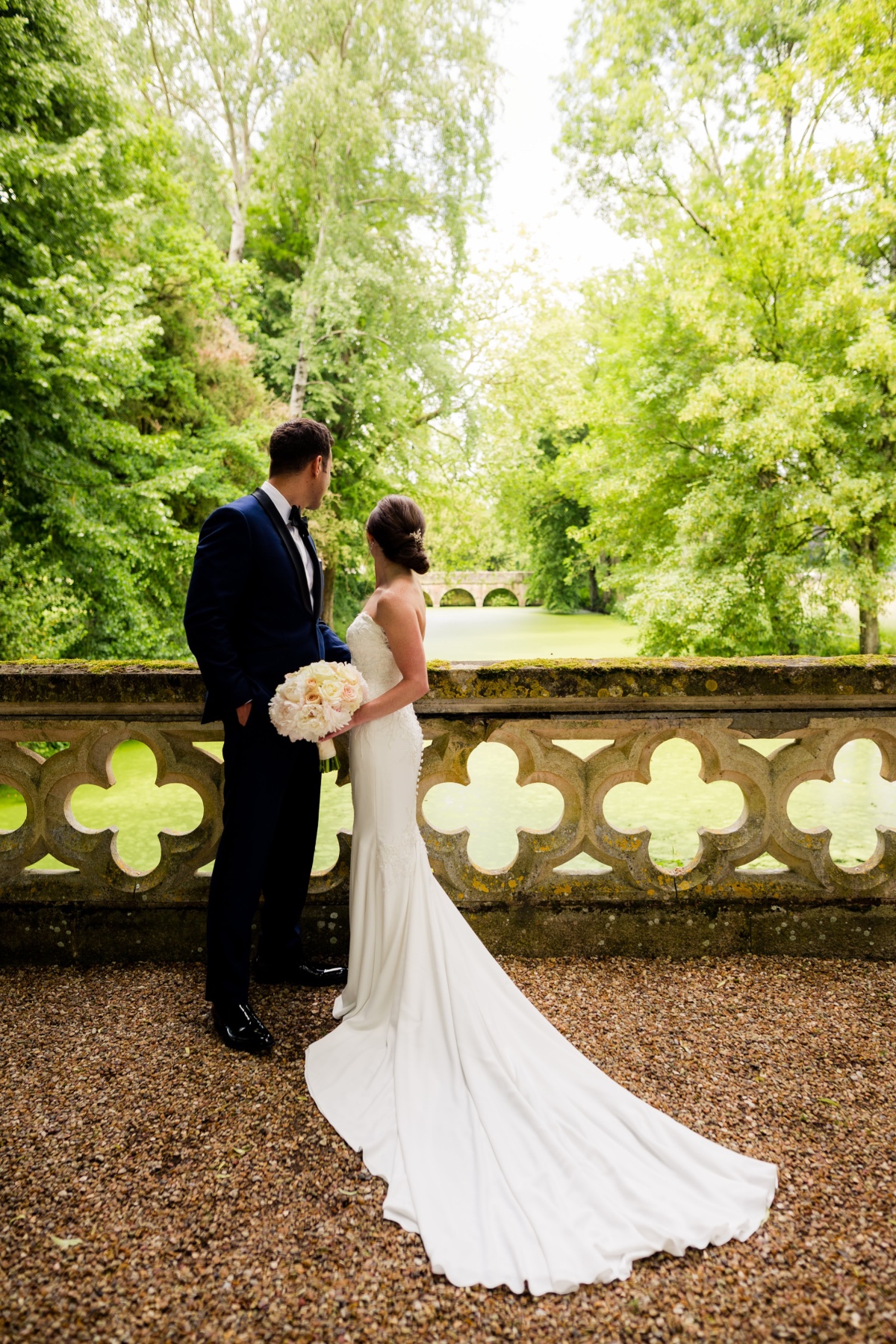 Wedding couple on stone balcony with green landscape view