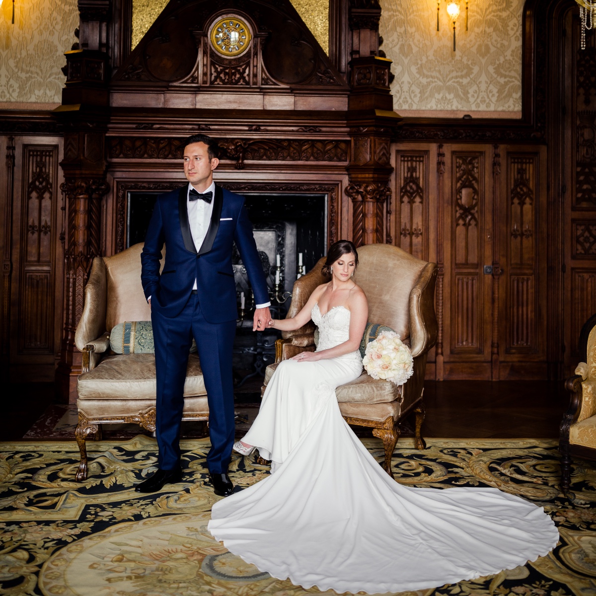 Elegant couple in wedding attire posing in a luxurious room