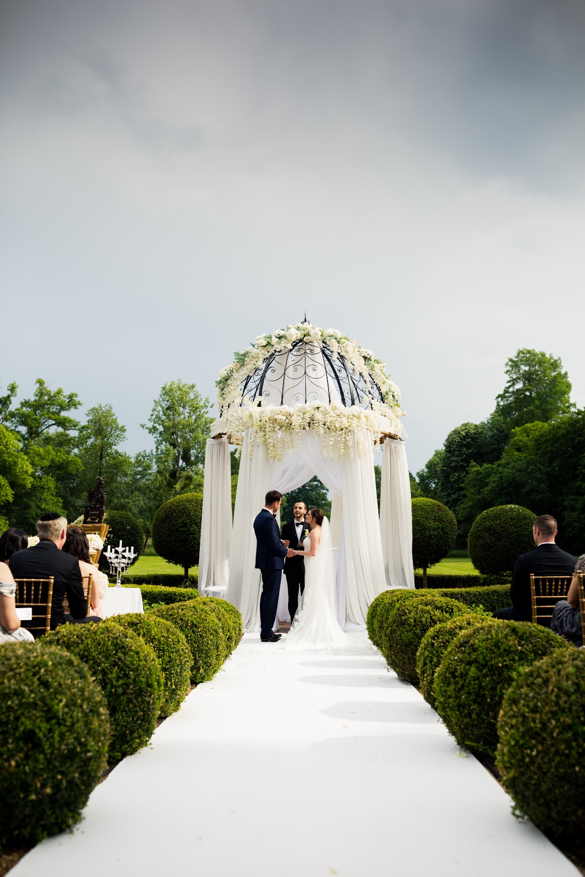 outdoor wedding ceremony in a manicured french garden