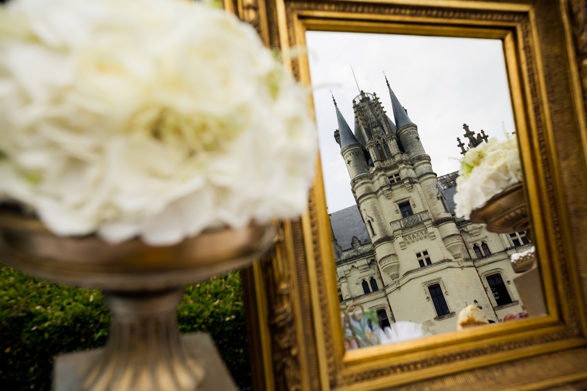 Golden framed castle reflection with white flower centerpiece