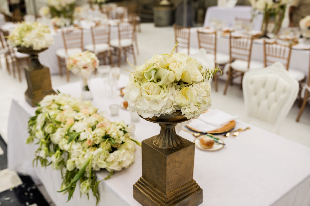 Elegant wedding table setting with white flowers and gold accents