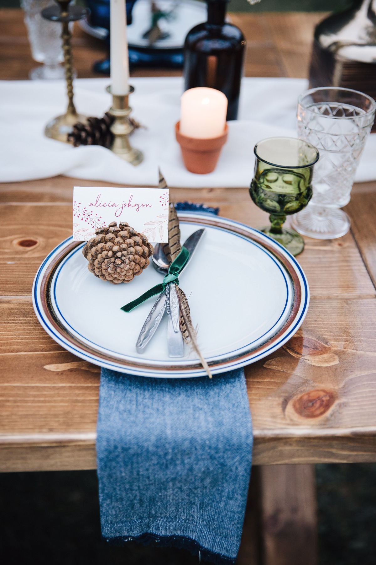 pinecone and feathers place setting decor