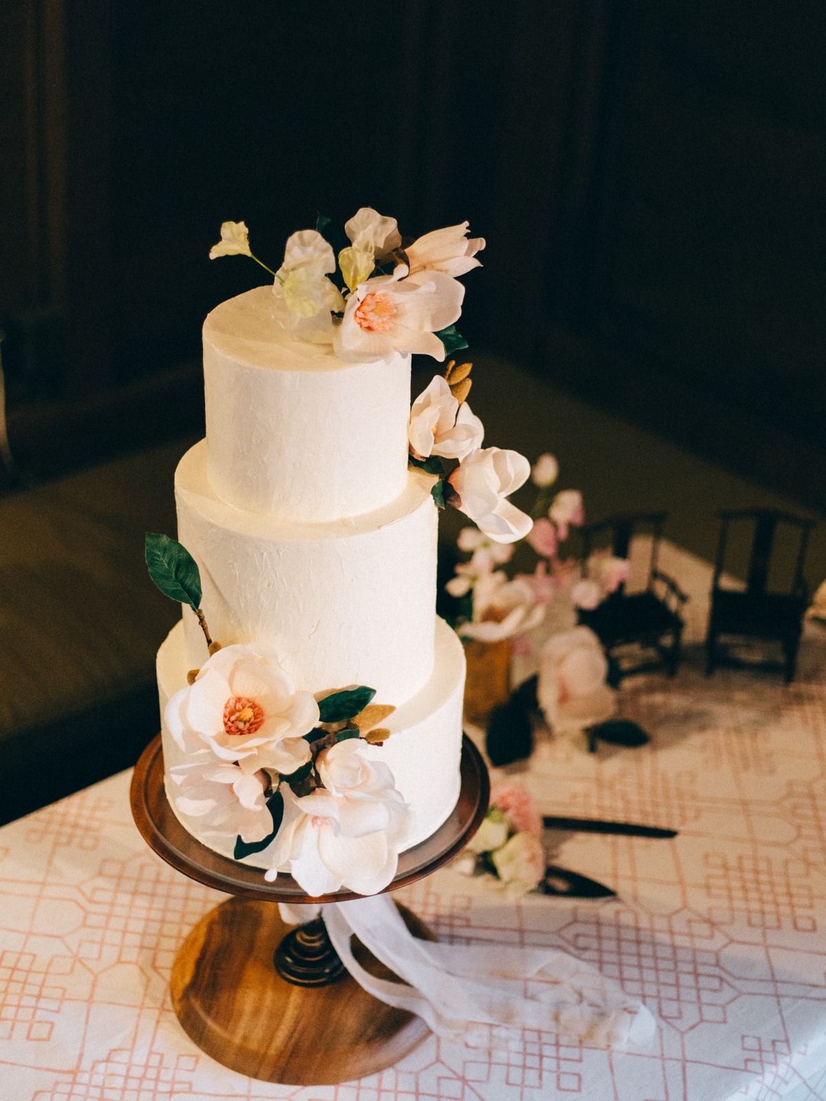 White wedding cake with magnolias