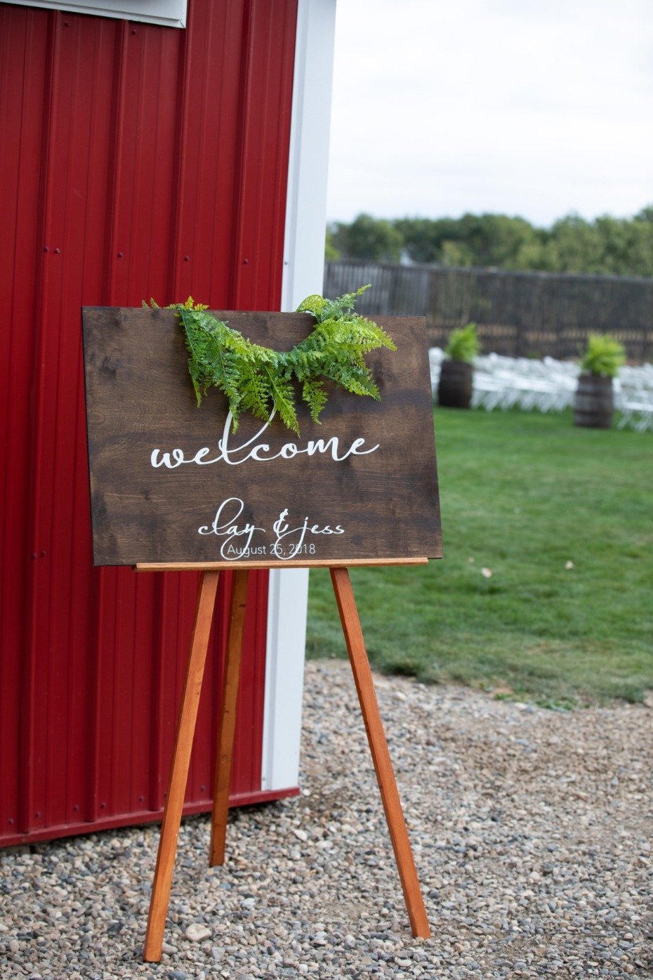 Rustic wedding welcome sign at barn venue for Clay and Jess
