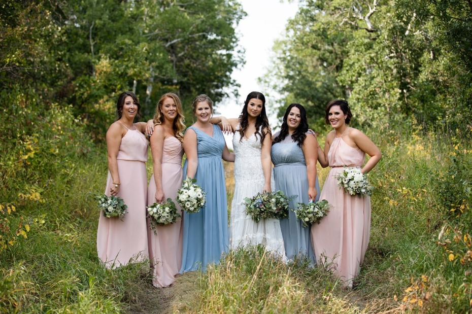 Happy wedding party bride and bridesmaids outdoors