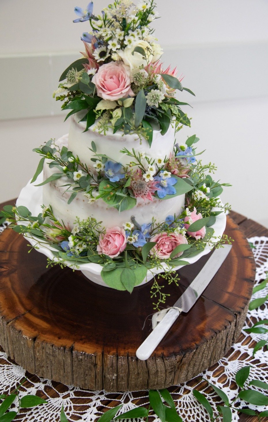 pink and blue floral topped wedding cake