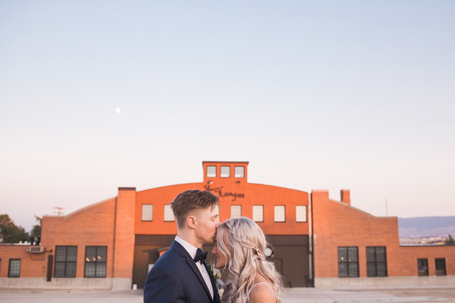 Romantic wedding moment with a couple in front of a building