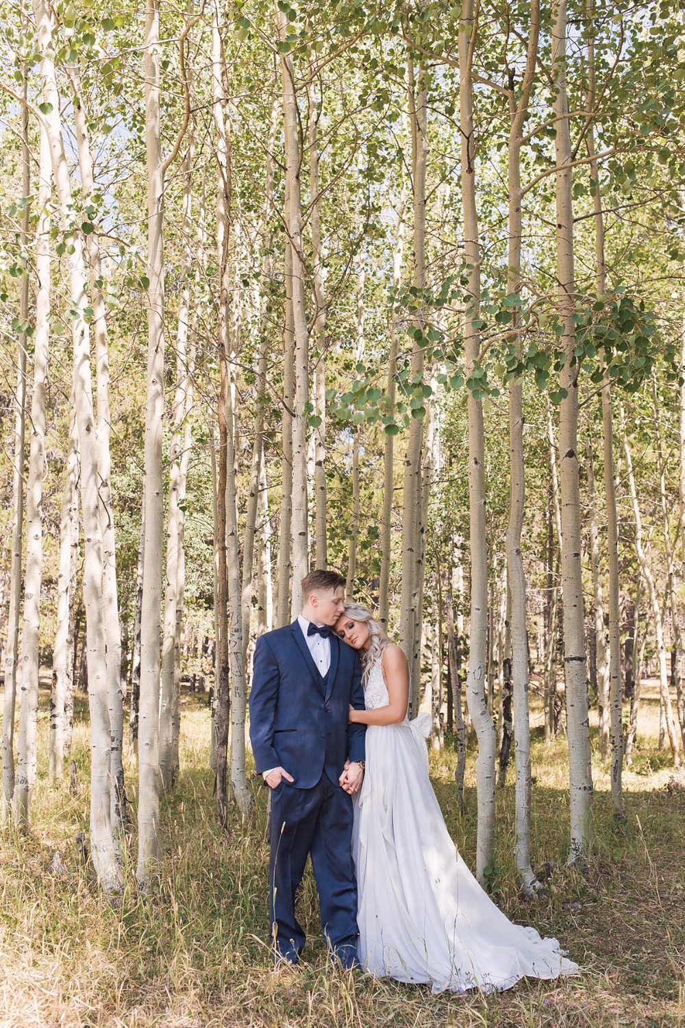 Happy couple embraces in aspen grove wedding photo