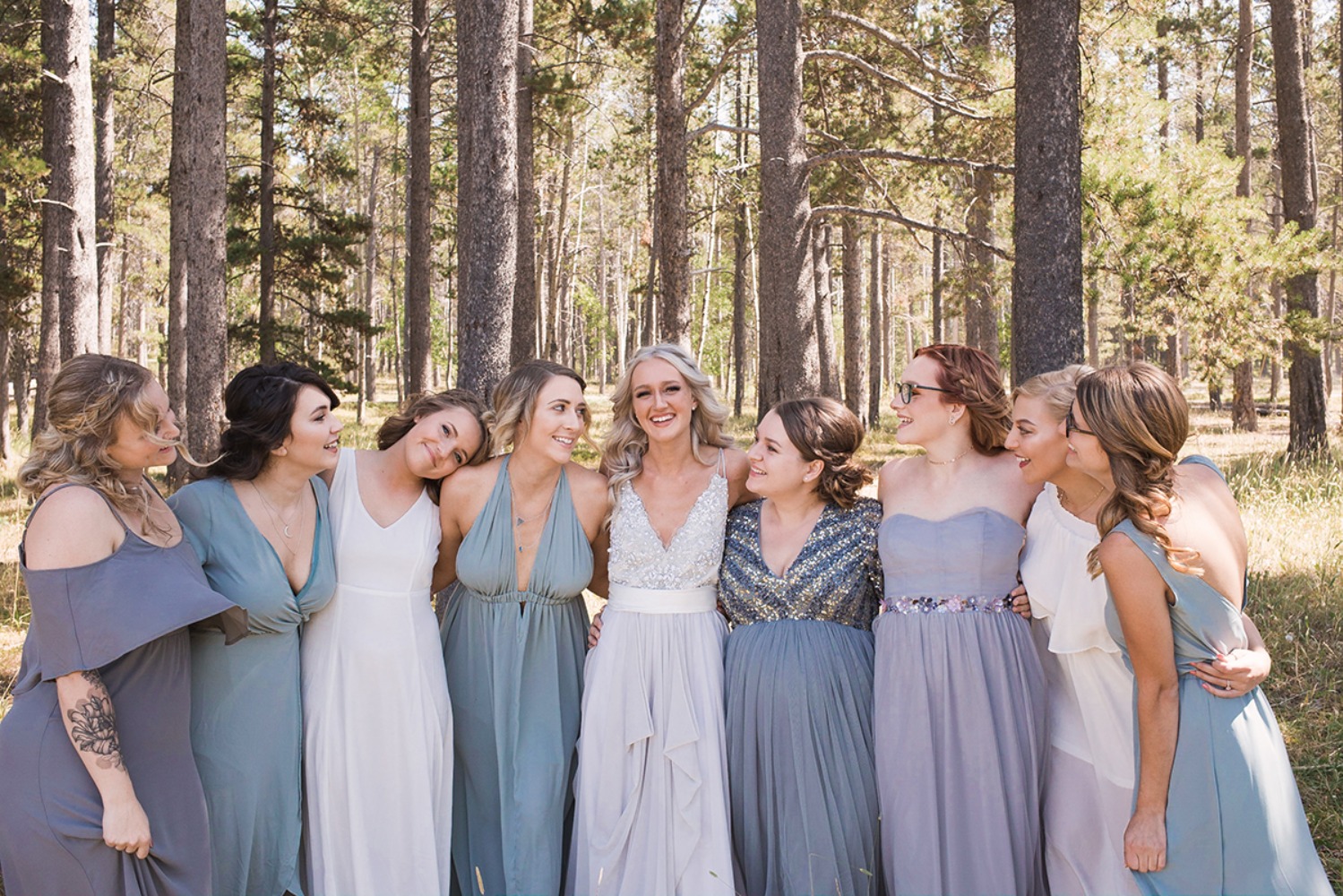 bride and her bridesmaids in mismatched blue