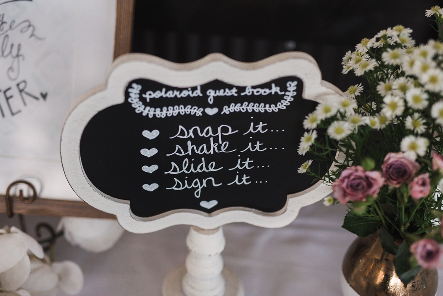 Wedding polaroid guest book sign with flowers for a party