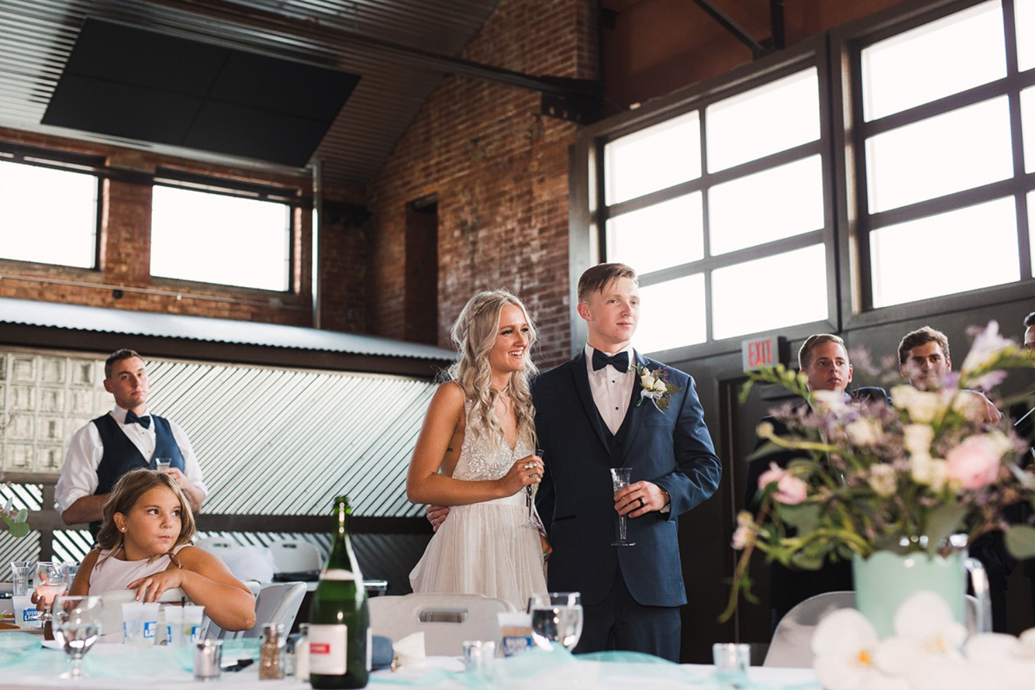 Smiling bride and groom at a wedding reception toast with champagne