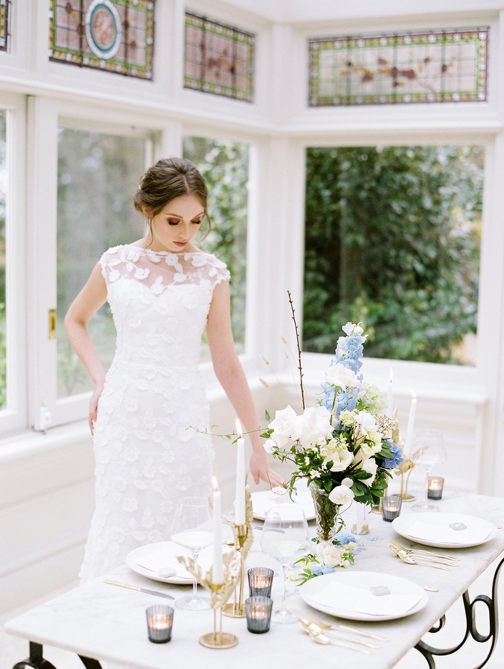 Bride in a white gown near a beautifully decorated table