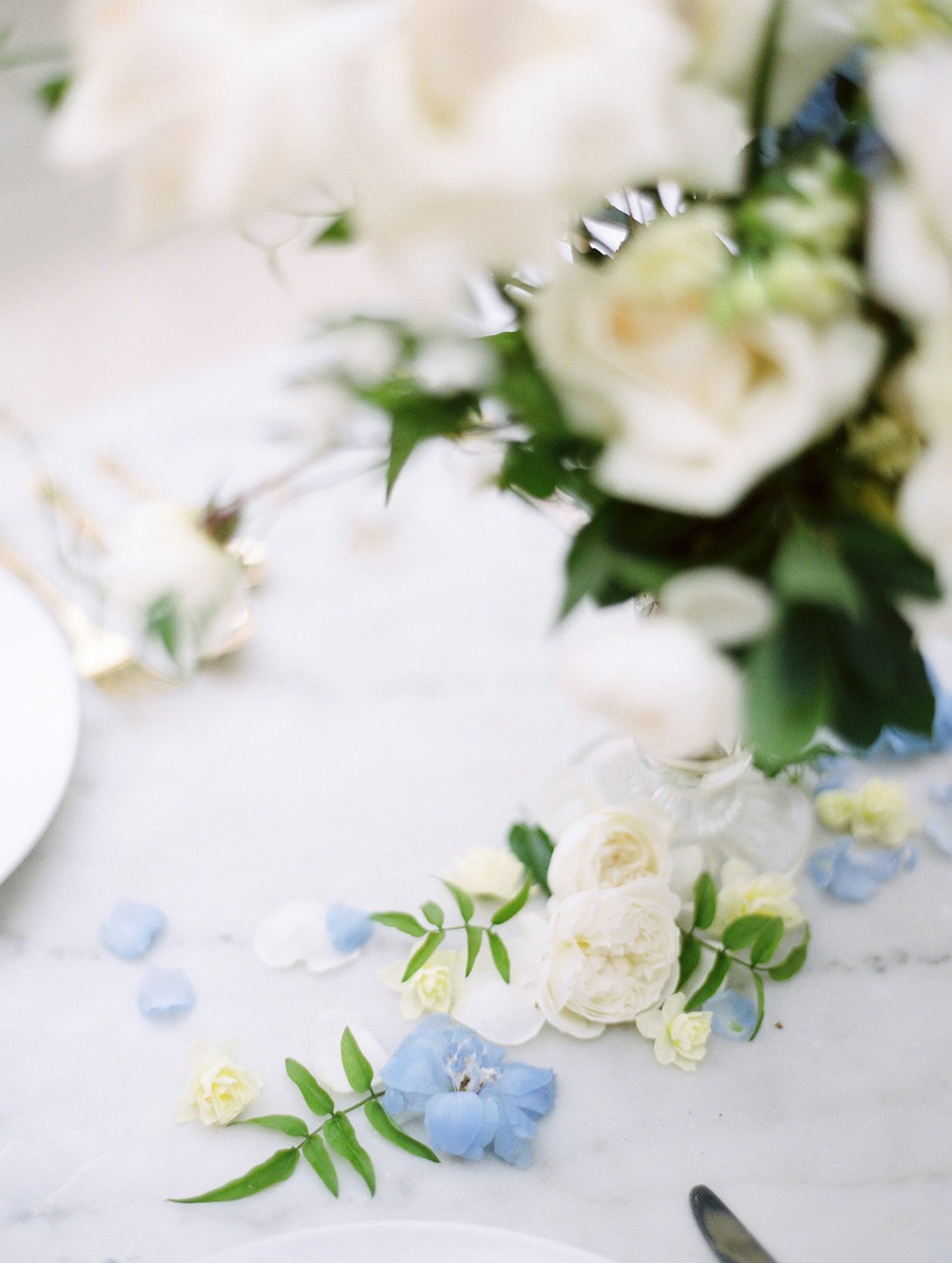 Elegant floral arrangement with soft white, blue, and yellow details
