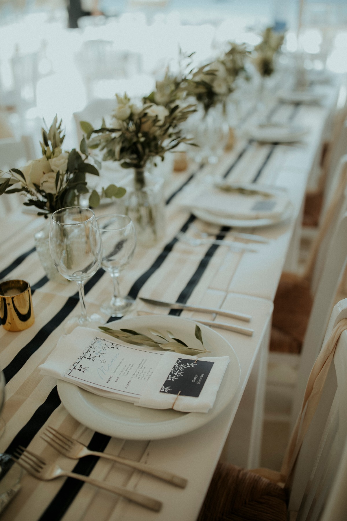 Elegant wedding dinner table with flowers and white plates
