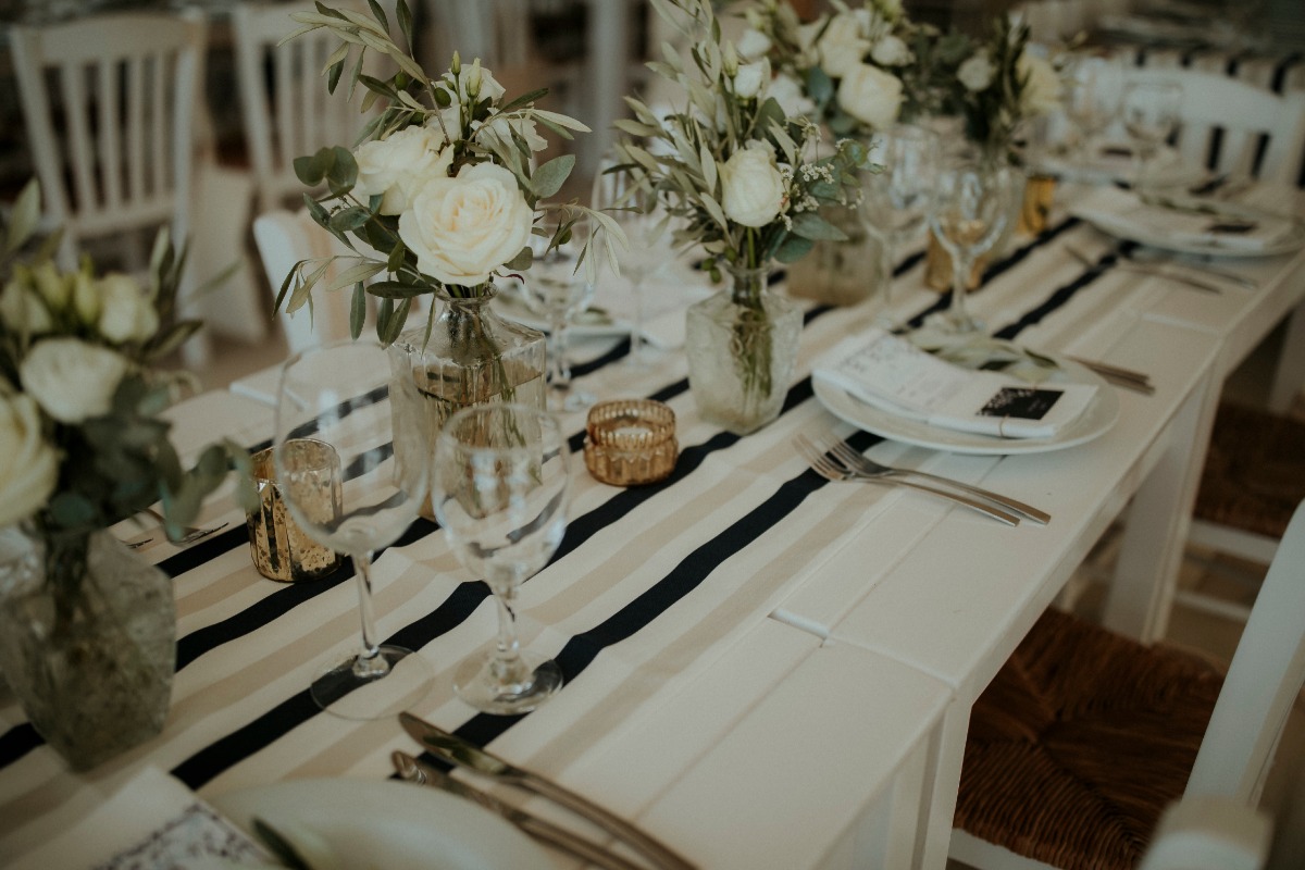 Elegant wedding table setting with white roses stripes