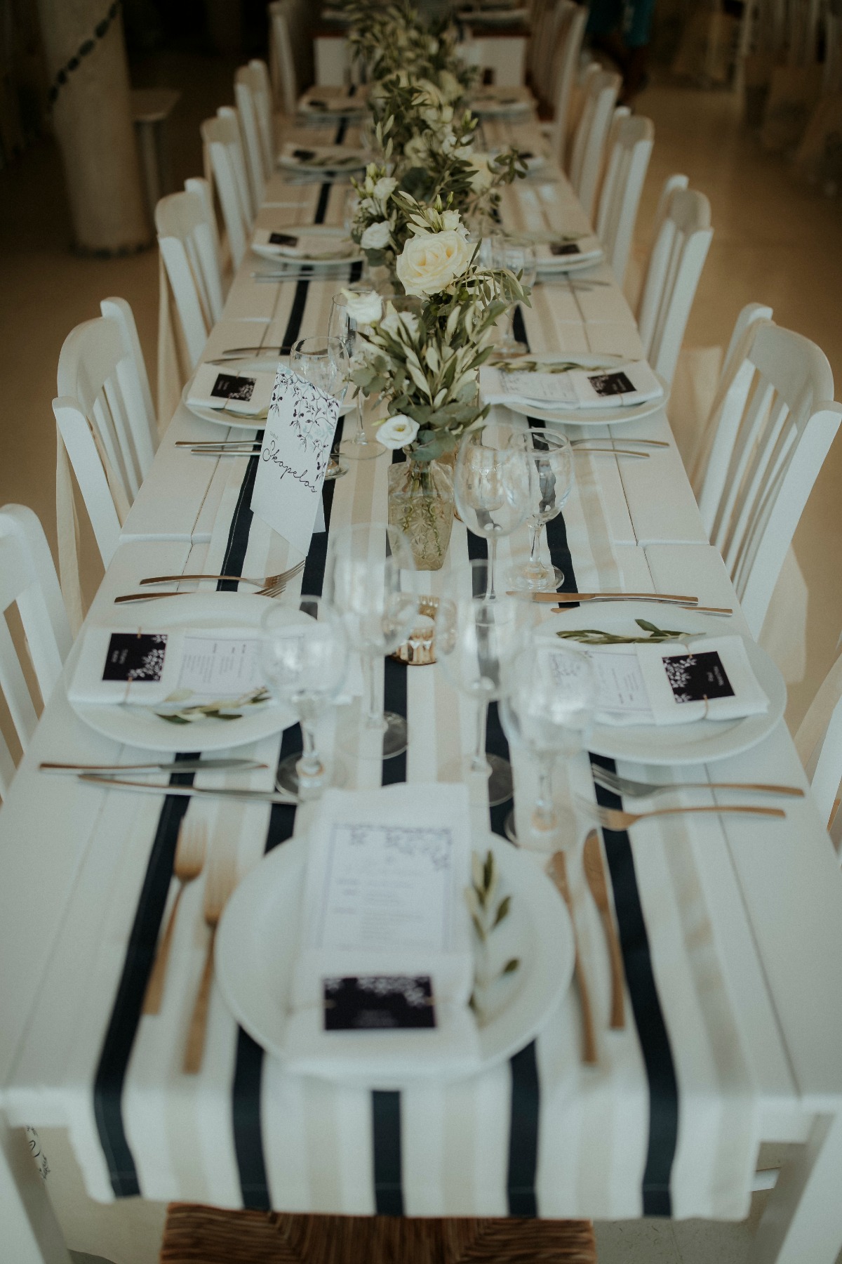 Elegant white wedding table setting with floral centerpiece