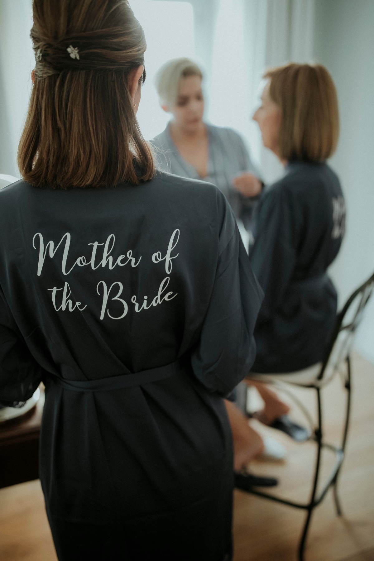 Brides mother wears robe saying Mother of the Bride before wedding