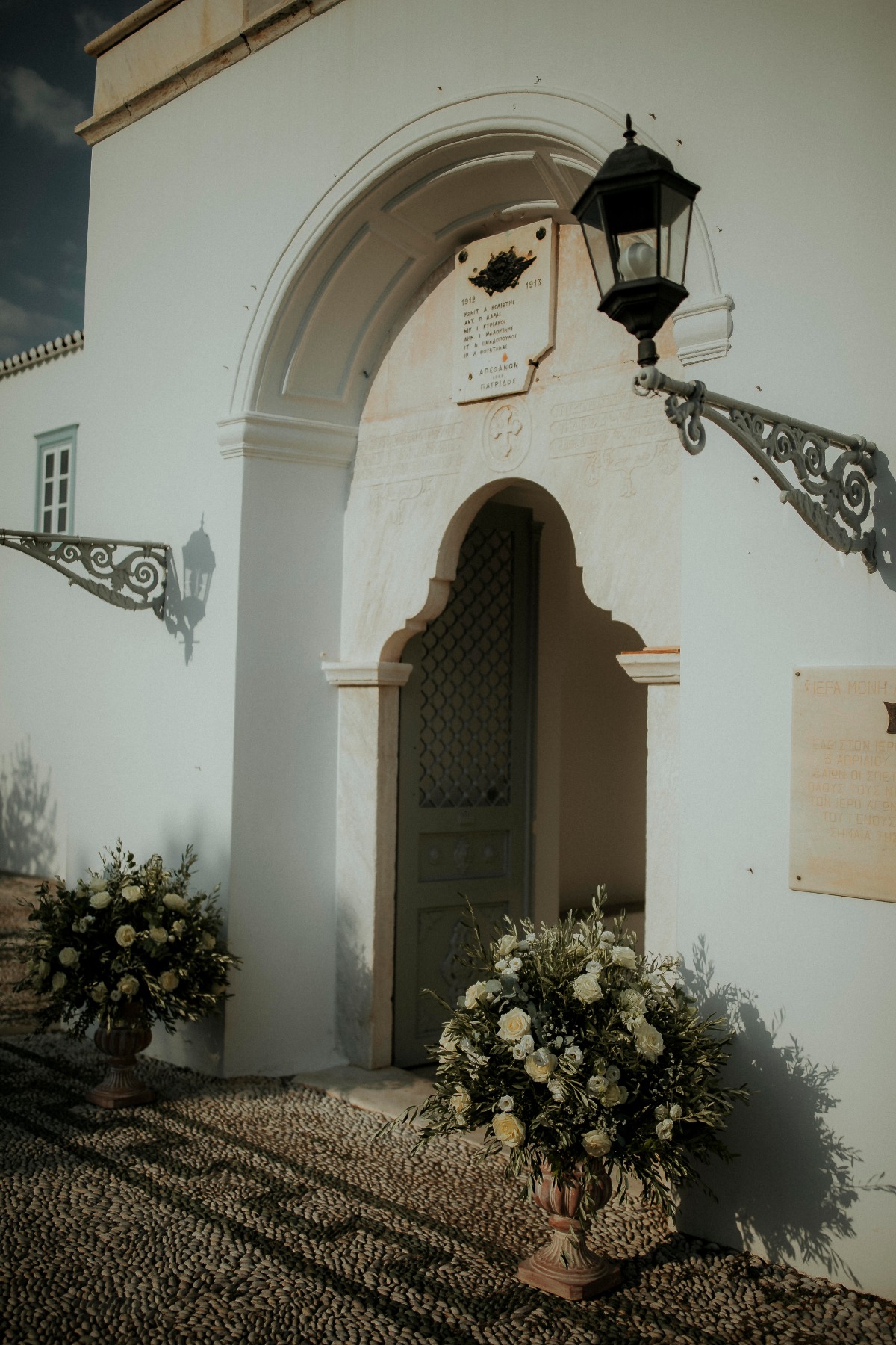 White building arched entrance with floral details