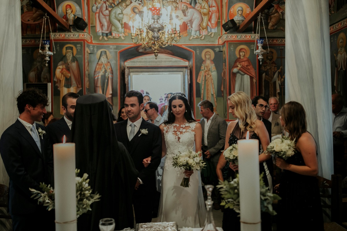 Bride and groom at a church wedding ceremony, surrounded by guests