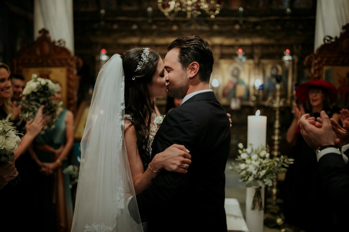 Bride and groom share first kiss at church wedding