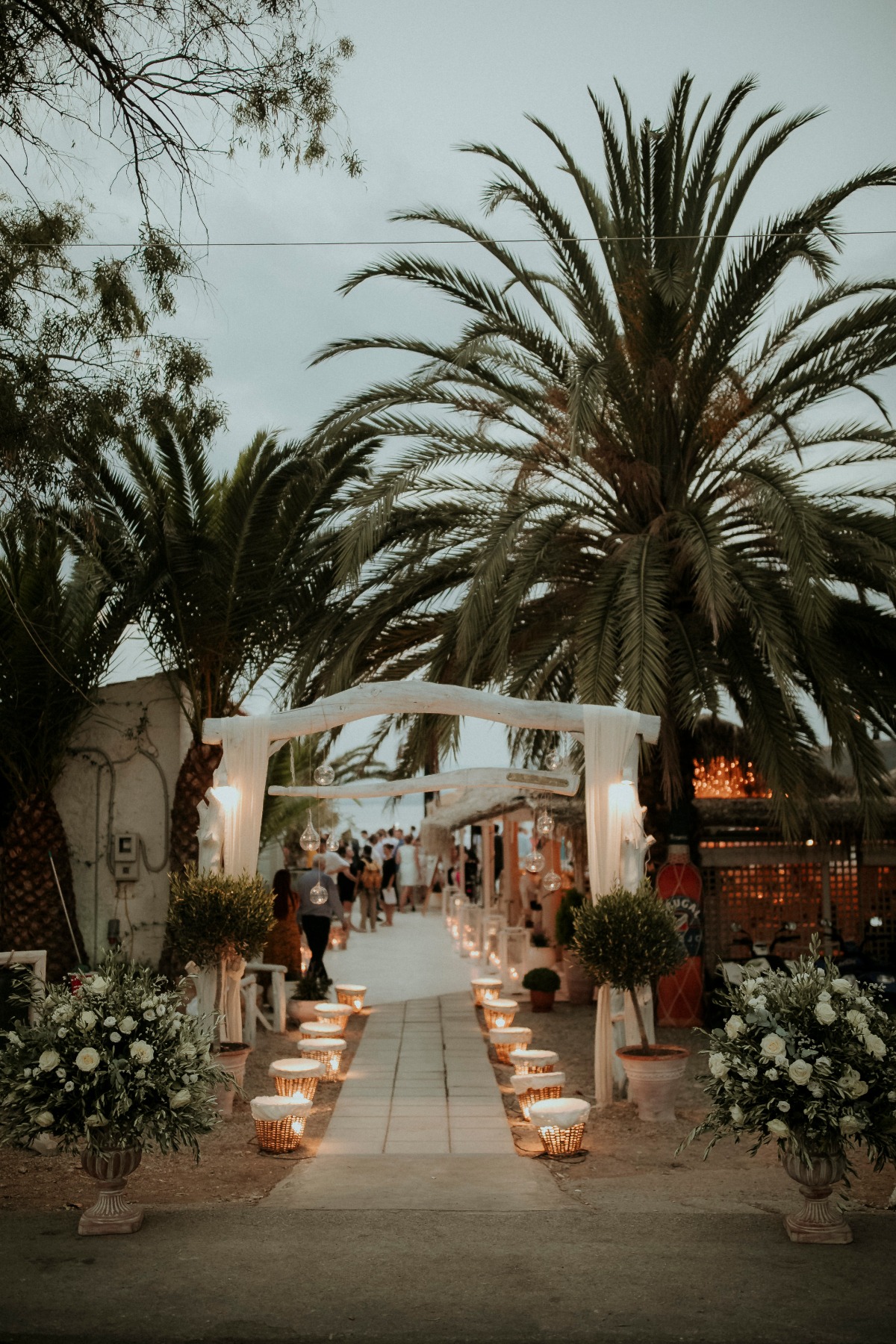 Outdoor wedding venue with palm trees and candle lights