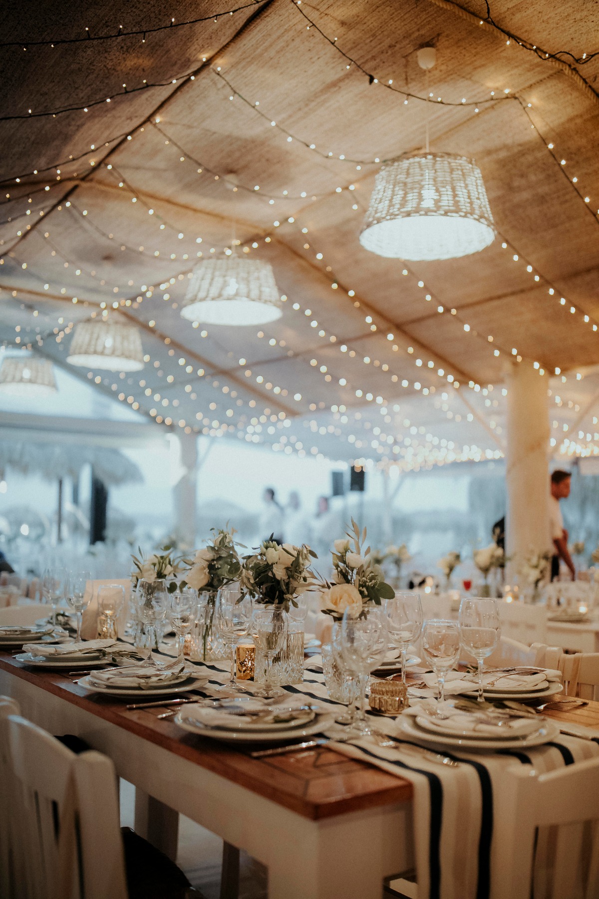 Wedding reception table lights and floral centerpiece