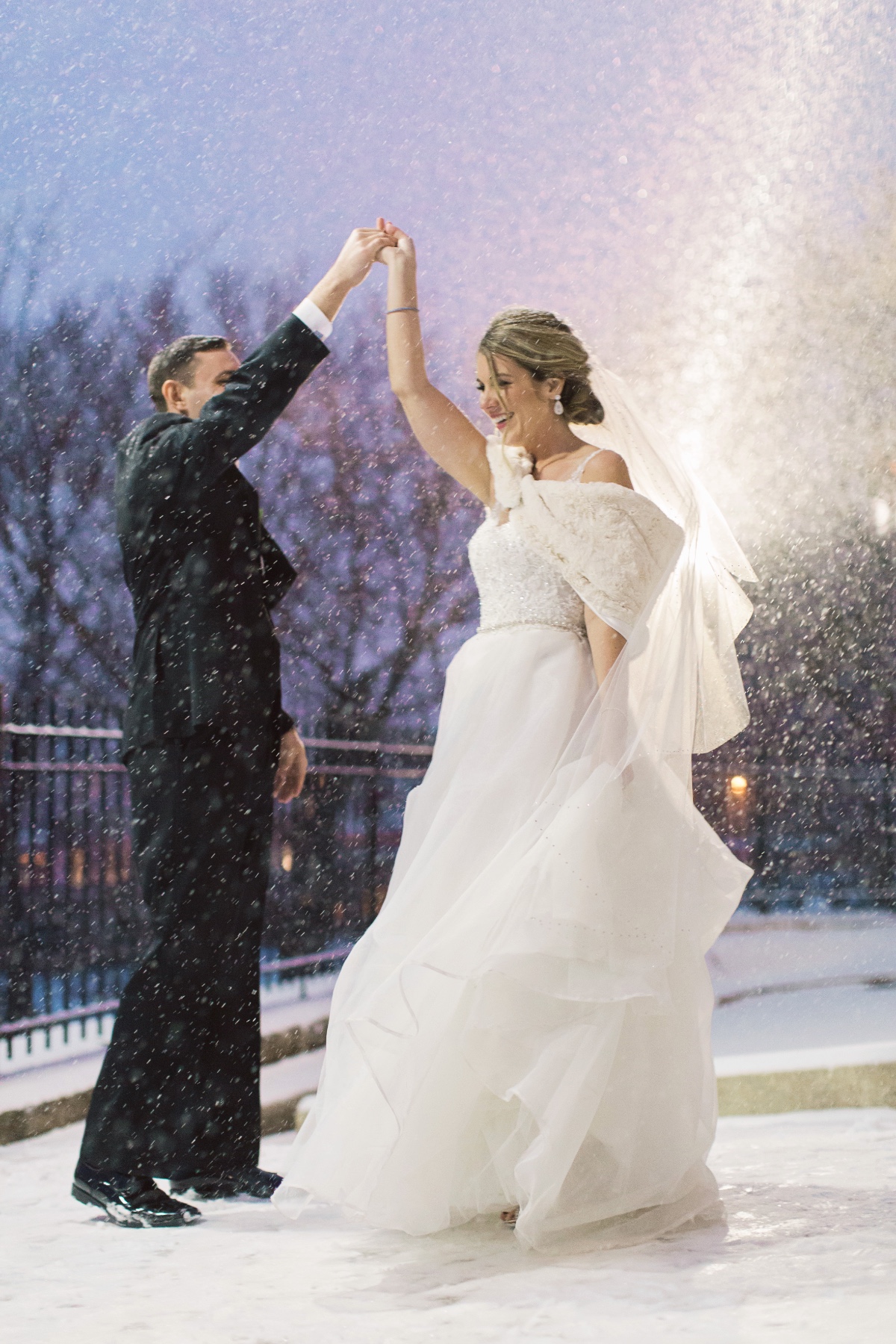 newlyweds dancing in the snow