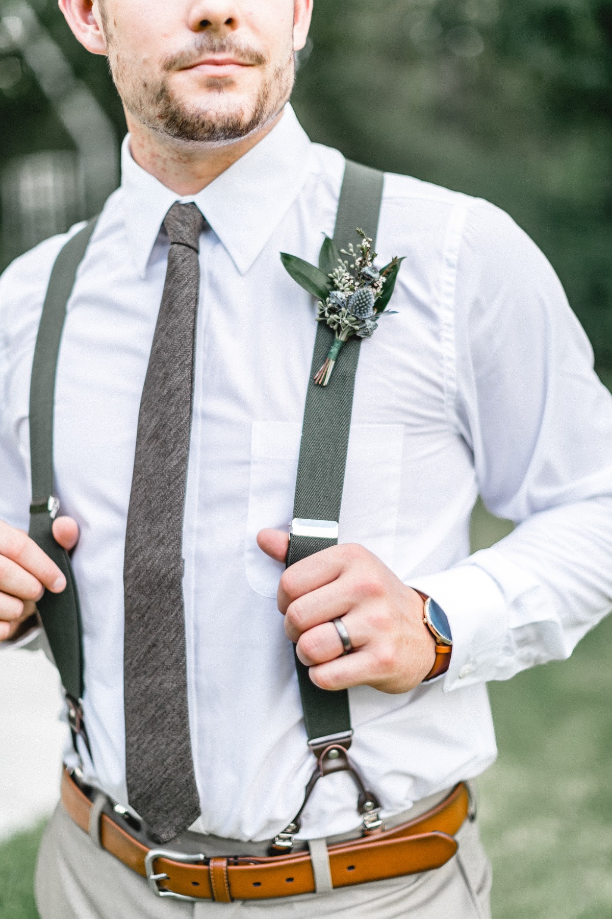 groom in suspenders