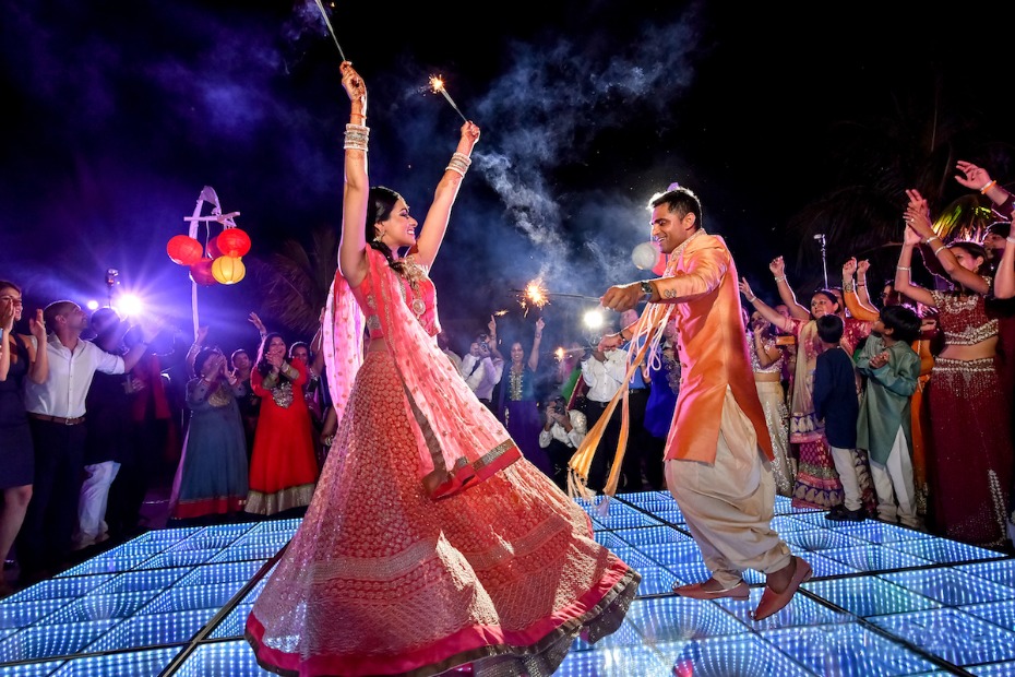 Indian wedding couple joyfully dances on a light-up floor