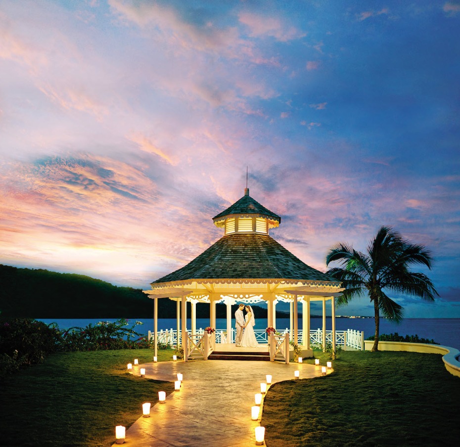 Romantic sunset wedding gazebo with couple
