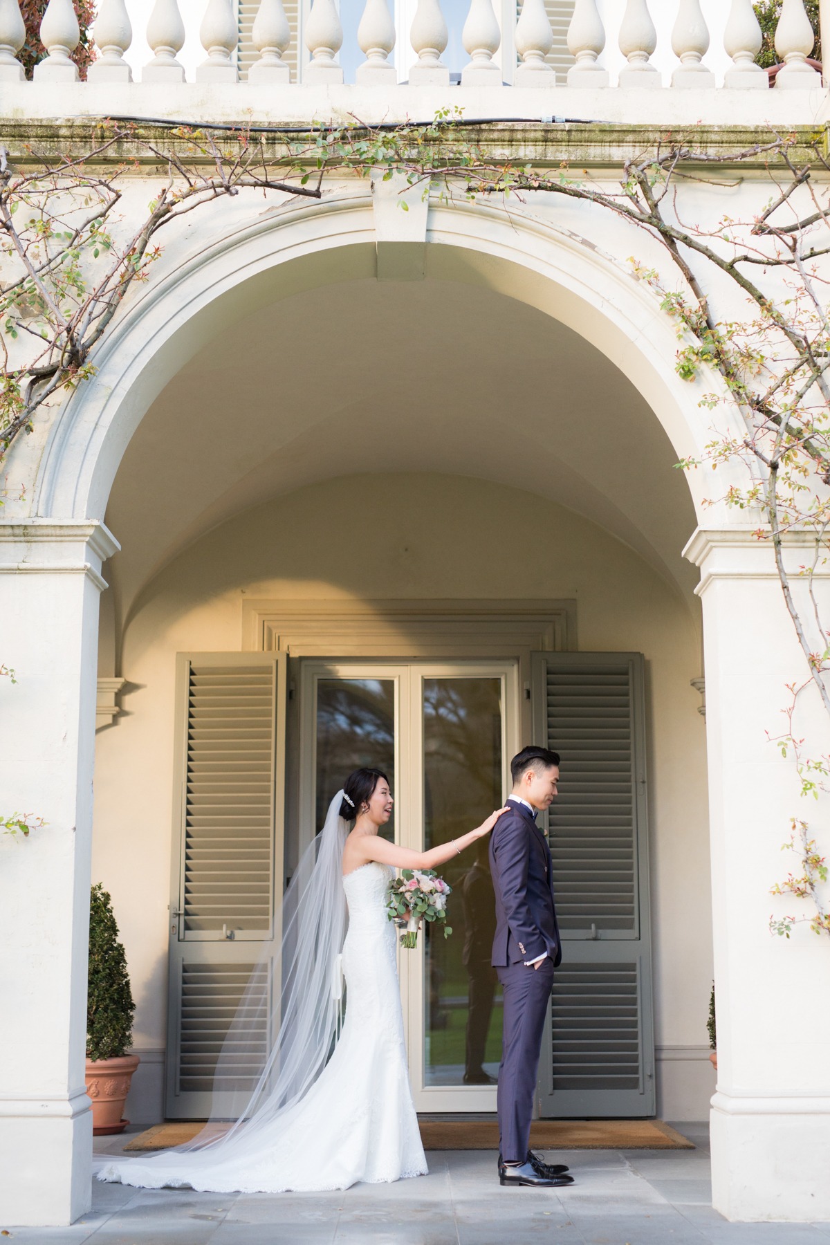 Bride touching grooms shoulder on their wedding day
