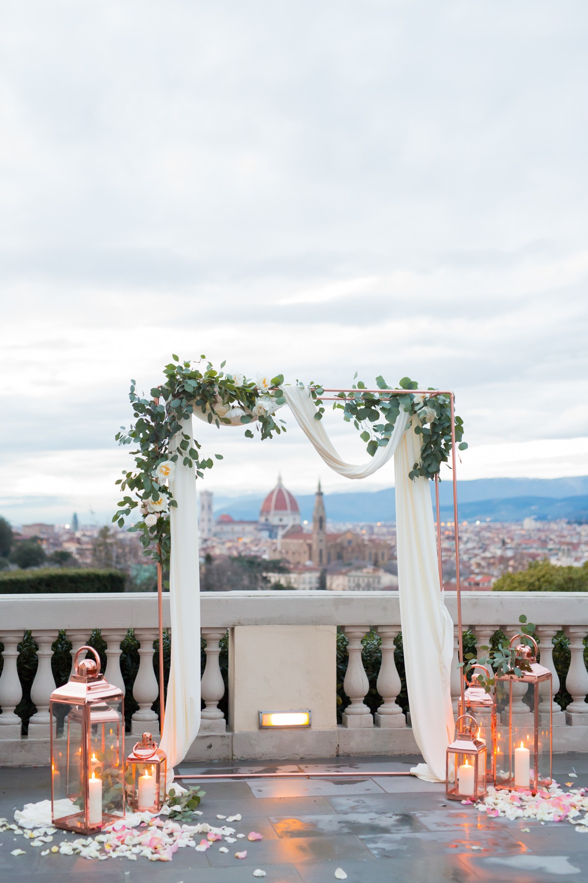 rose gold candle lit lanterns and arch over looking Florence Italy