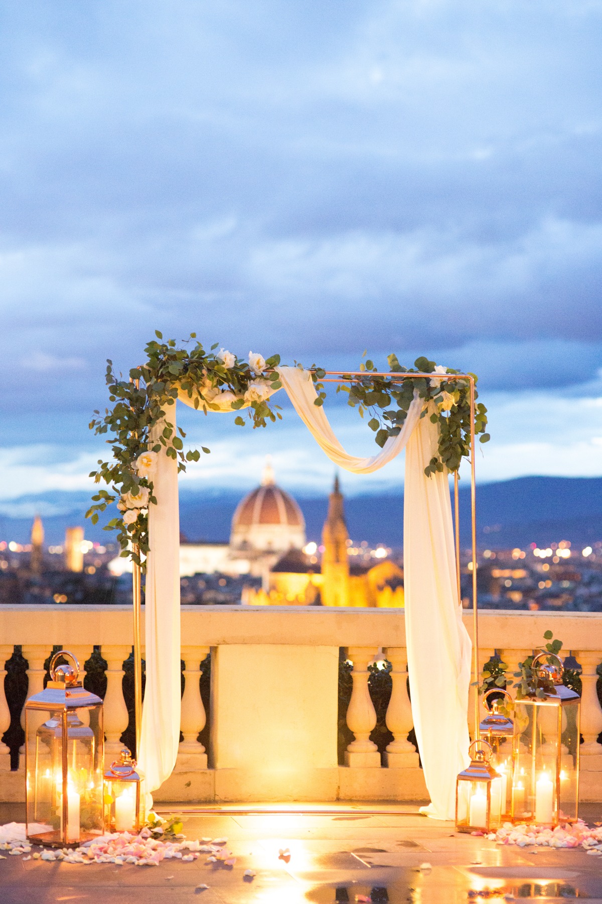 Elegant outdoor wedding setting with city skyline and lanterns