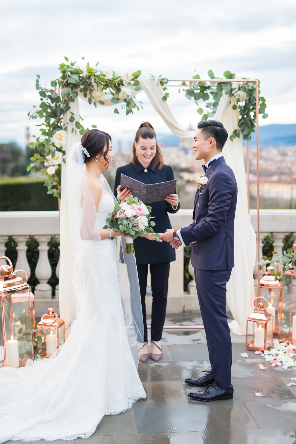 Couple exchanging vows at outdoor wedding ceremony